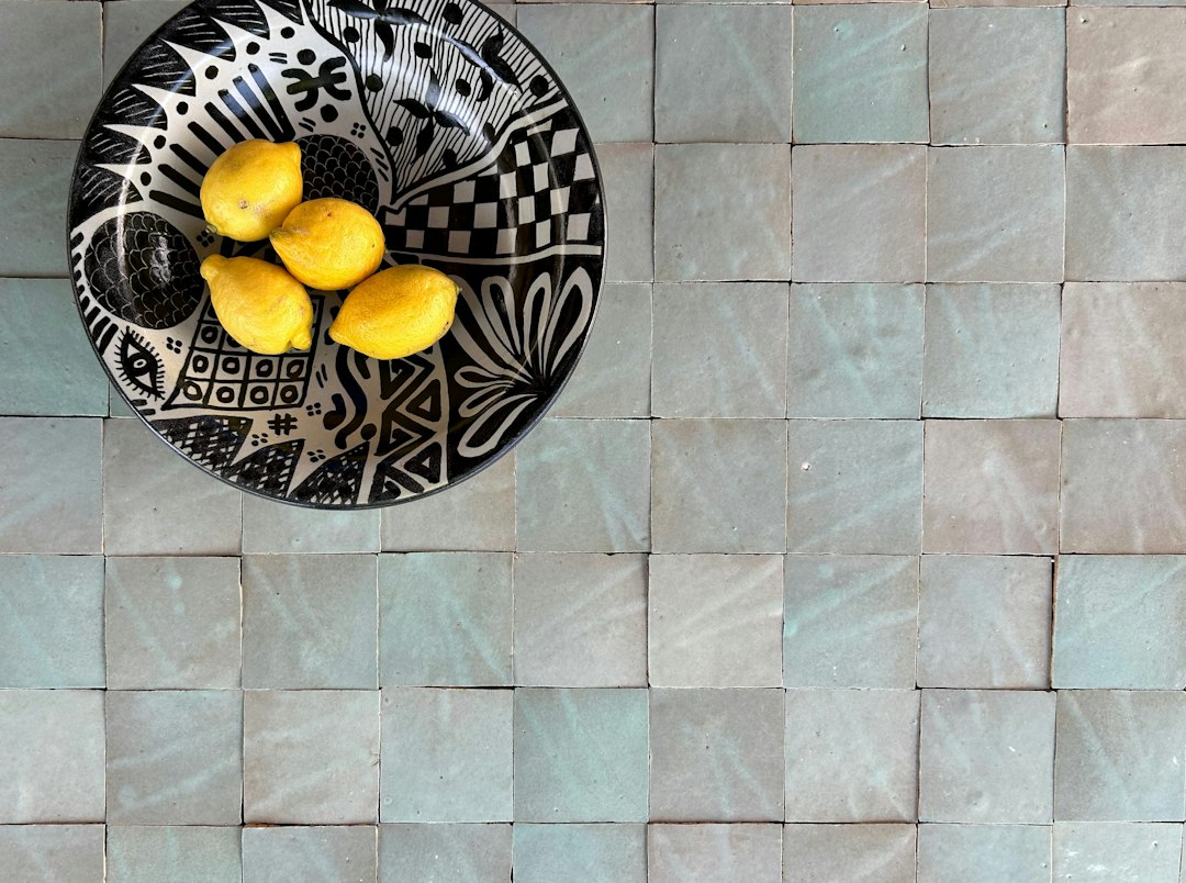 white zellige tile kitchen backsplash with brass fixtures
