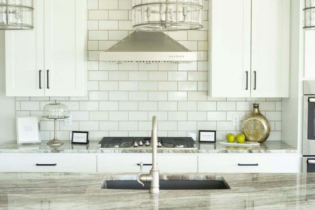 white kitchen with tile backsplash and open shelves