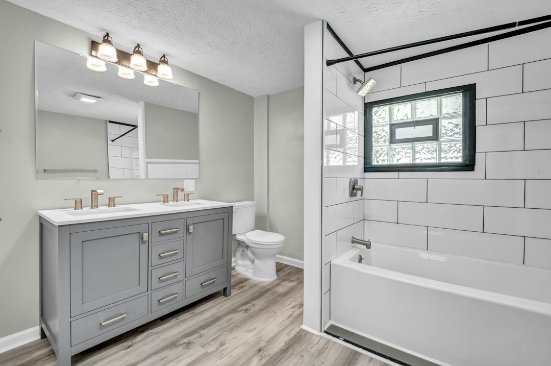 wood look porcelain plank tile bathroom floor with white vanity