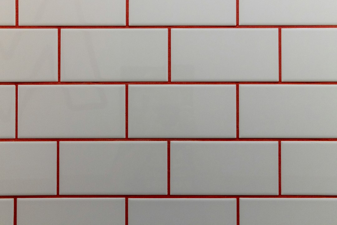gray grout lines on white marble mosaic kitchen backsplash close up