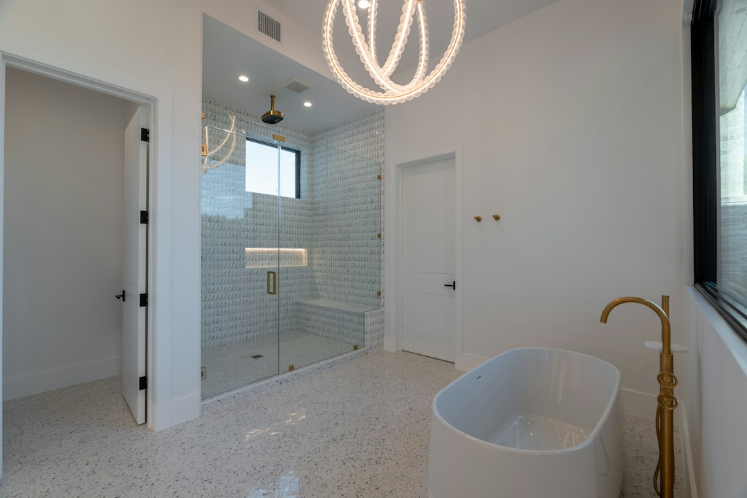 white hexagon mosaic tile bathroom floor with black grout